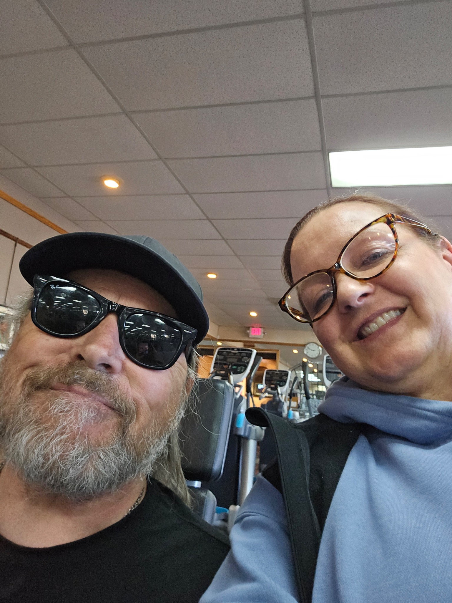 Debbie smiling with a client at the gym